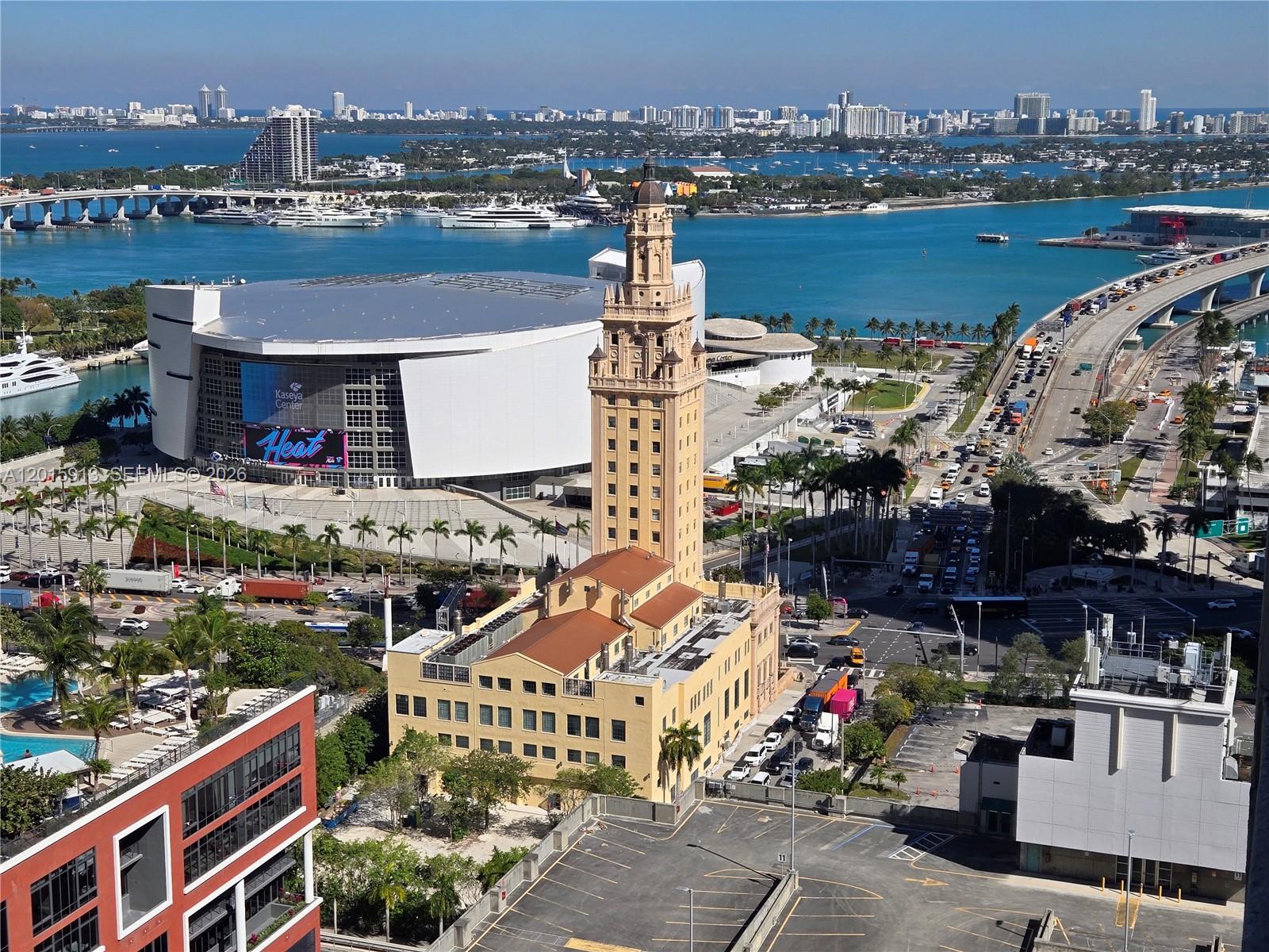 An aerial view shows the Freedom Tower, Kaseya Center, and surrounding Miami waterfront and highways — 121 NE 5 ST # 2908, Miami FL 33132, MIAMI, FL