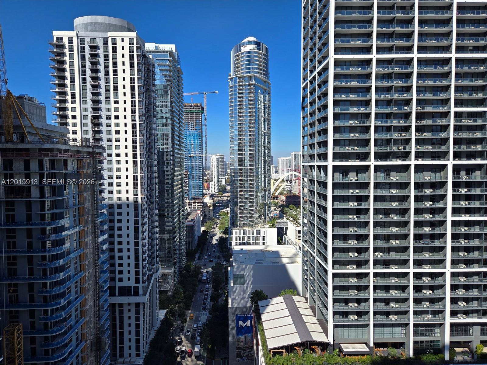 An elevated view shows a city street lined with modern high-rise apartment buildings and construction — 121 NE 5 ST # 2908, Miami FL 33132, MIAMI, FL