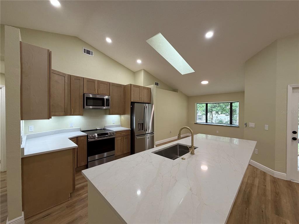 A bathroom features a glass-enclosed corner shower with grey tile and a separate toilet area — 329 SUN OAKS COURT, LAKE MARY, FL