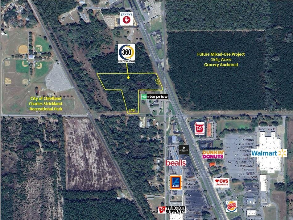 An aerial map shows a highlighted parcel of land near commercial businesses and a park — TBD US HWY 19 (N YOUNG BLVD), CHIEFLAND, FL