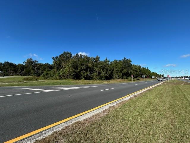 A paved road runs alongside a grassy shoulder and a line of trees — TBD US HWY 19 (N YOUNG BLVD), CHIEFLAND, FL