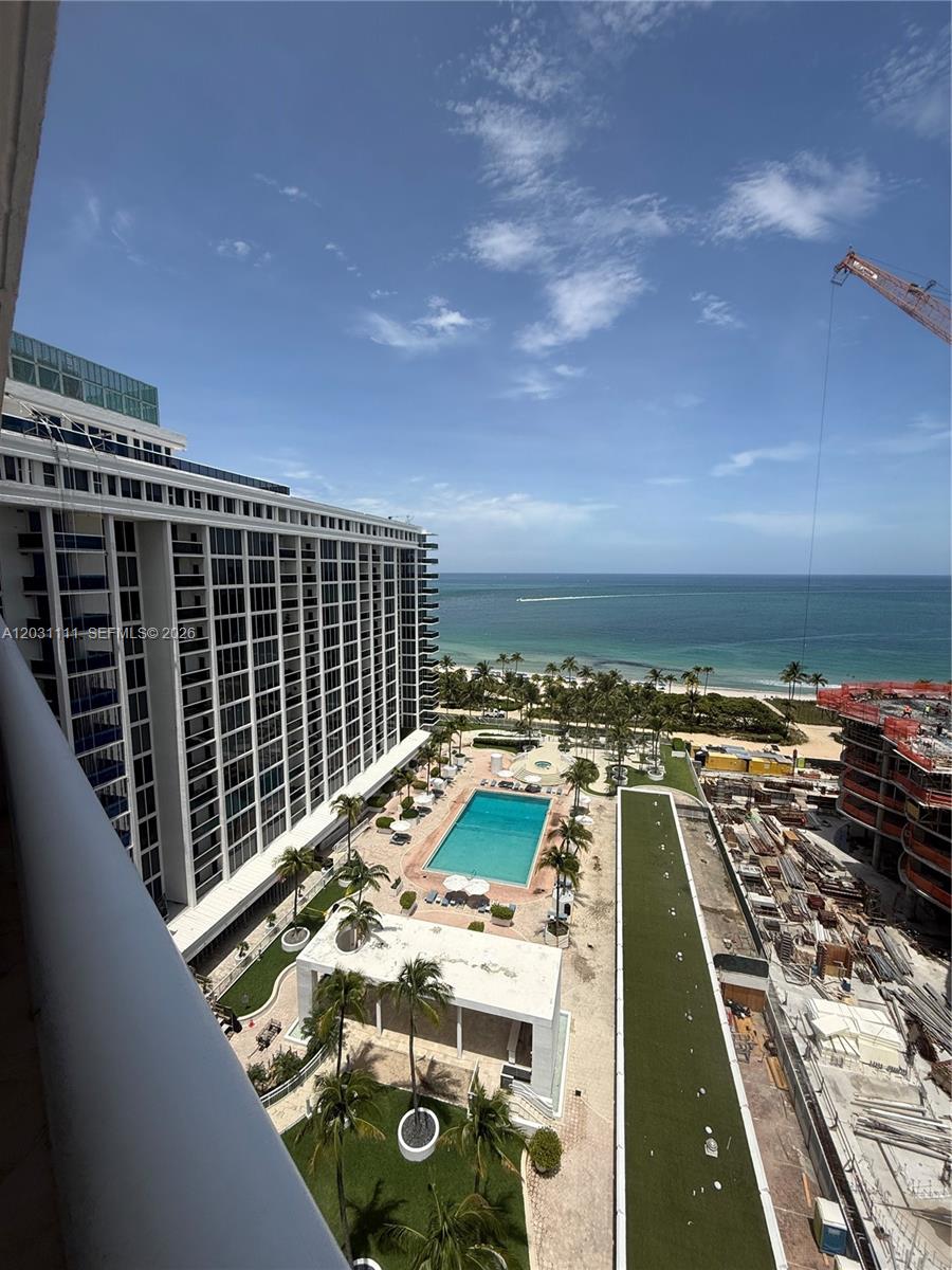 An elevated view shows a swimming pool, a grassy area, and a construction site by the ocean — 10275 Collins Ave # 921, Bal Harbour FL 33154, BAL HARBOUR, FL