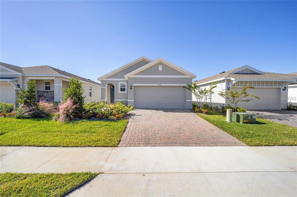 A single-story suburban house with a paved driveway and a two-car garage — 5430 NW 46TH LANE, OCALA, FL
