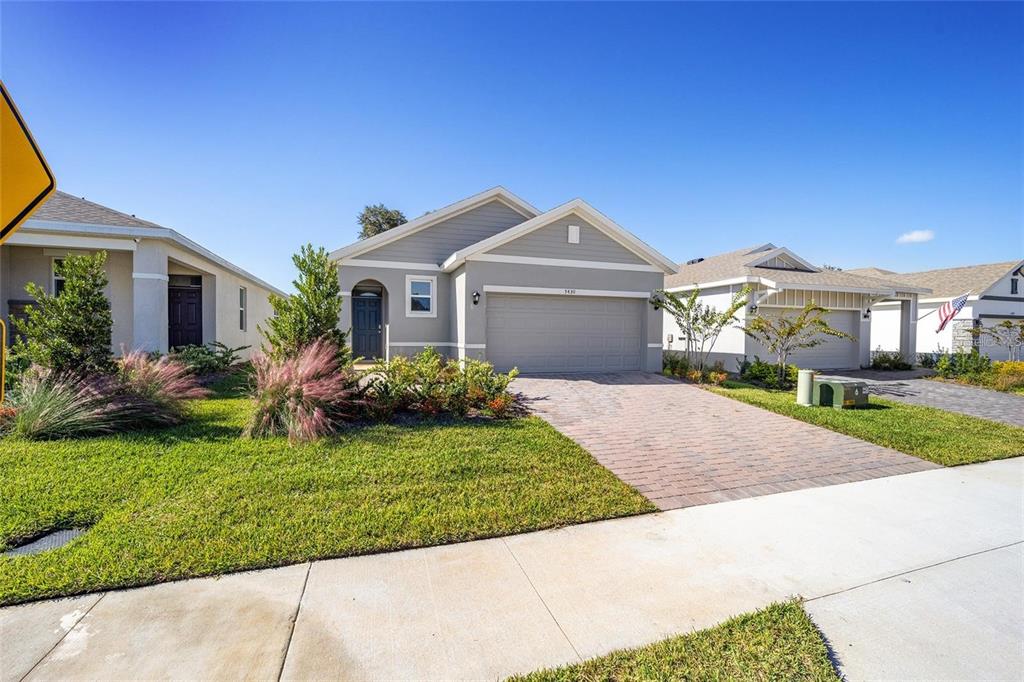 A single-story gray house with a two-car garage and a paved driveway — 5430 NW 46TH LANE, OCALA, FL