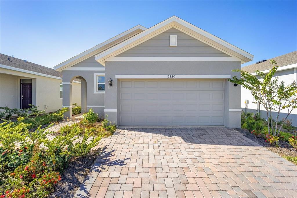 A single-story house with a gray exterior, a two-car garage, and a paved driveway — 5430 NW 46TH LANE, OCALA, FL