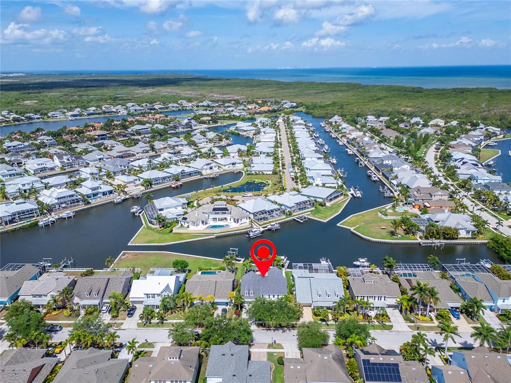 An aerial view shows a waterfront residential neighborhood with a red pin marking a house — 5722 SEA TROUT PLACE, APOLLO BEACH, FL