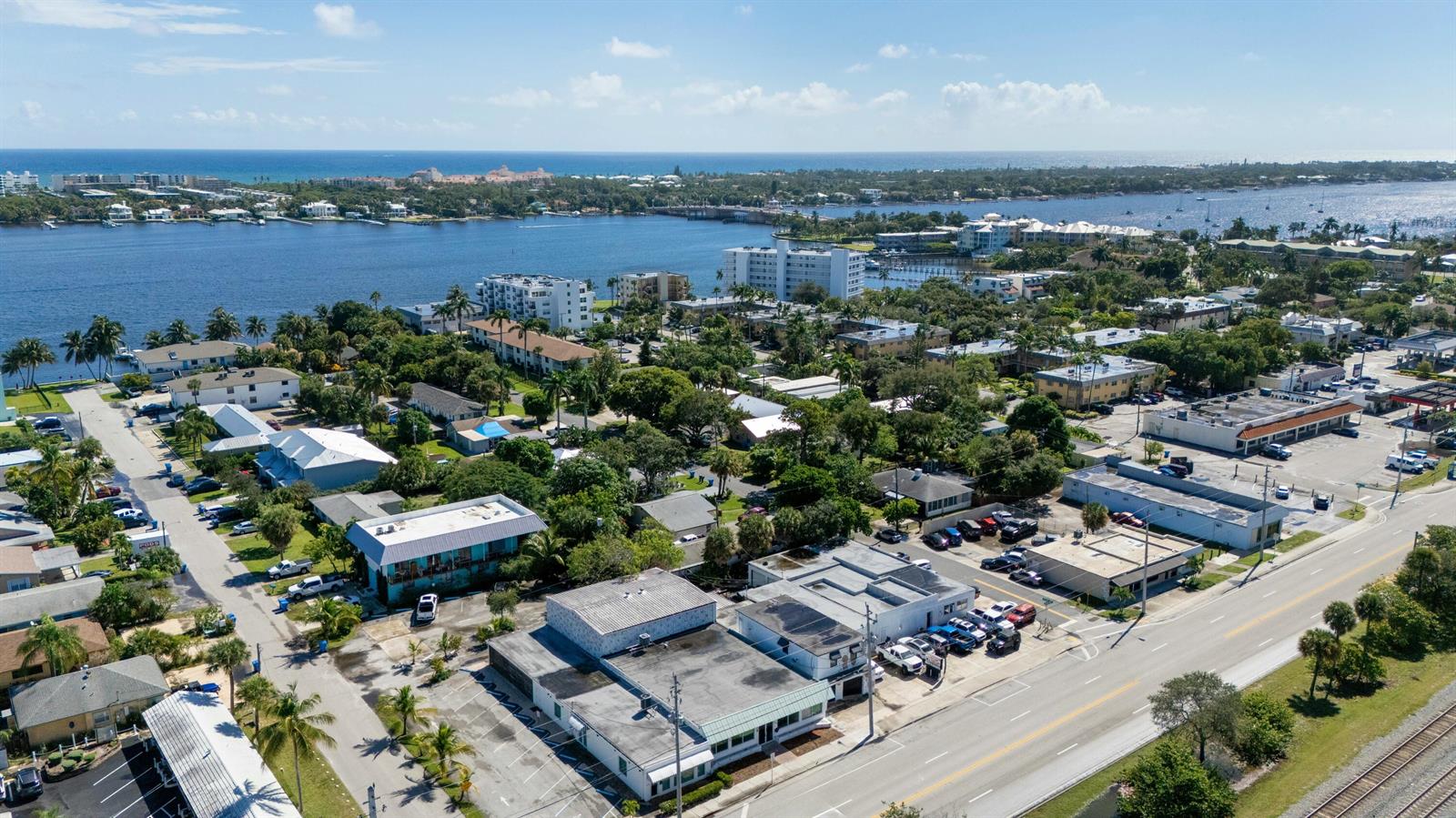 An aerial view shows a coastal town with commercial buildings, parking lots, and a waterway — 604 N Dixie Highway, Lantana FL 33462, LANTANA, FL
