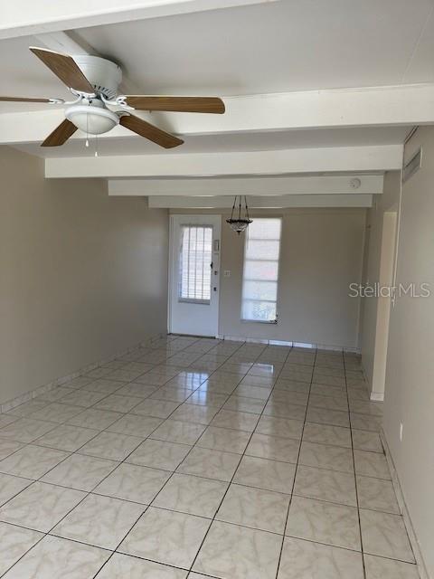 An empty room features light-colored tile flooring, a ceiling fan, and a glass-paned exterior door — 2709 CLUB CIRCLE, LAKE WALES, FL