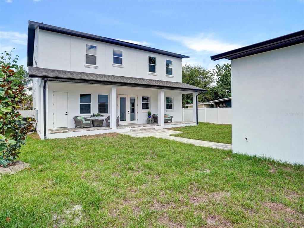A two-story white house with a covered patio and a grassy backyard — 1420 36TH AVENUE N, ST PETERSBURG, FL