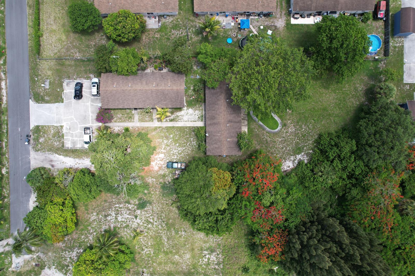 An aerial view shows two rectangular buildings with brown roofs surrounded by trees and lawns — 4537 Coconut Road, Lake Worth FL 33461, LAKE WORTH, FL