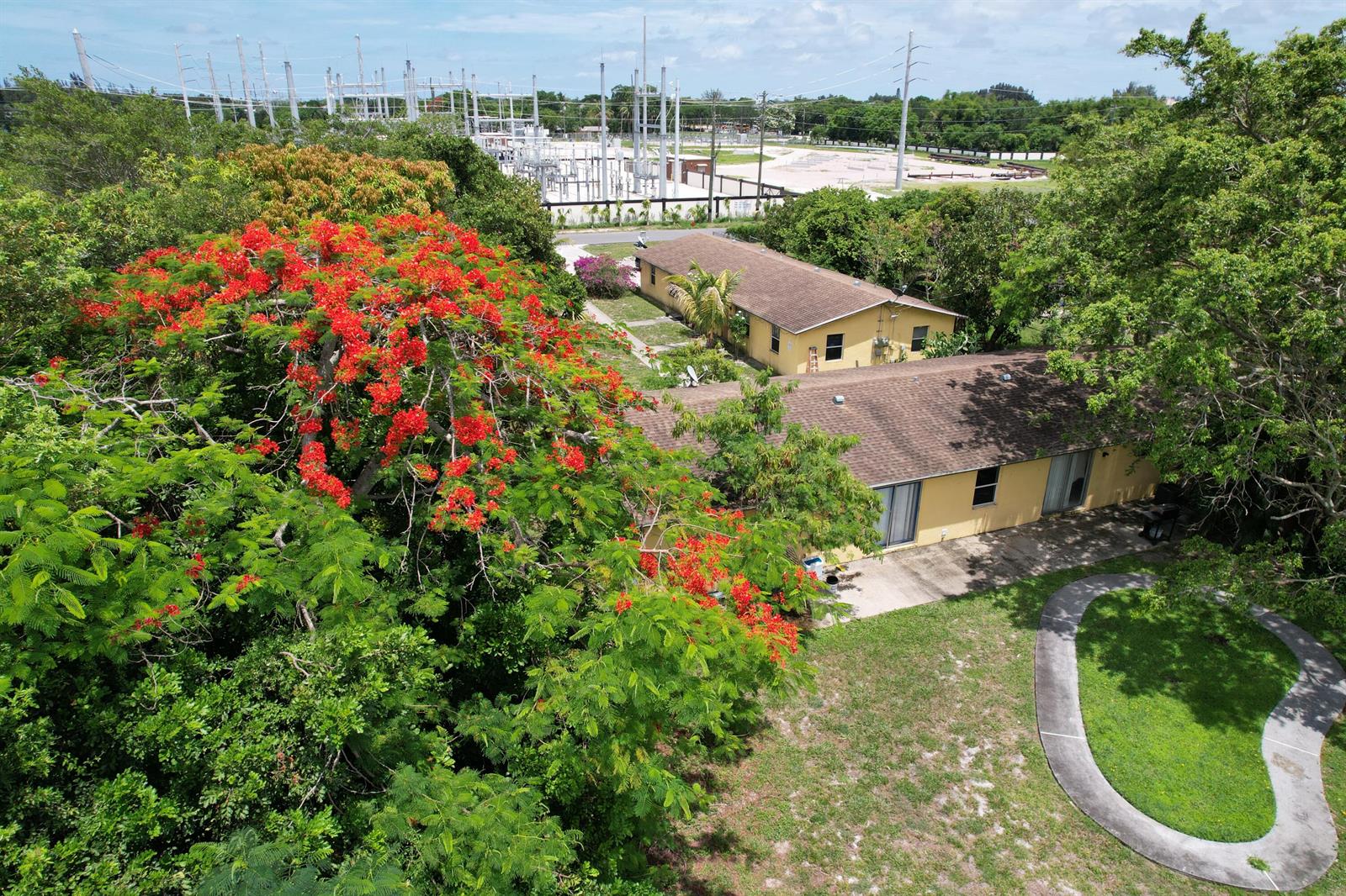 An aerial view shows two yellow single-story houses near a large electrical substation and trees — 4537 Coconut Road, Lake Worth FL 33461, LAKE WORTH, FL