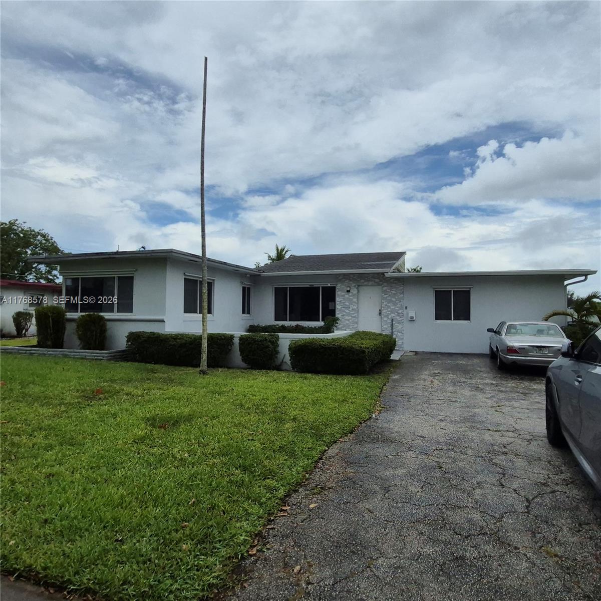 A single-story house with a flat roof, a paved driveway, and a front lawn — 8320 NW 10 Ave, Miami FL 33150, MIAMI, FL
