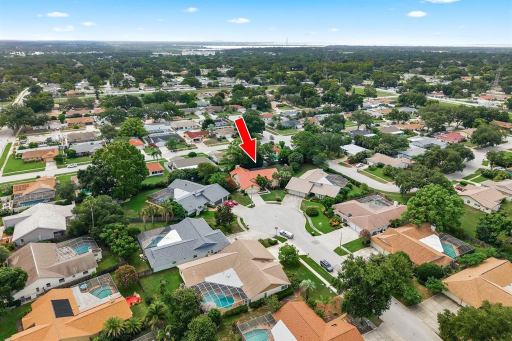 An aerial view shows a residential neighborhood with a red arrow pointing to a house — 2729 REDFORD COURT E, CLEARWATER, FL