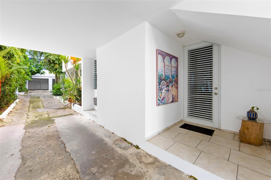 A covered entryway features a white door with horizontal slats, tiled flooring, and a painting — 424 DEL VALLE ST MONTEFLORES DEV, SAN JUAN, PR
