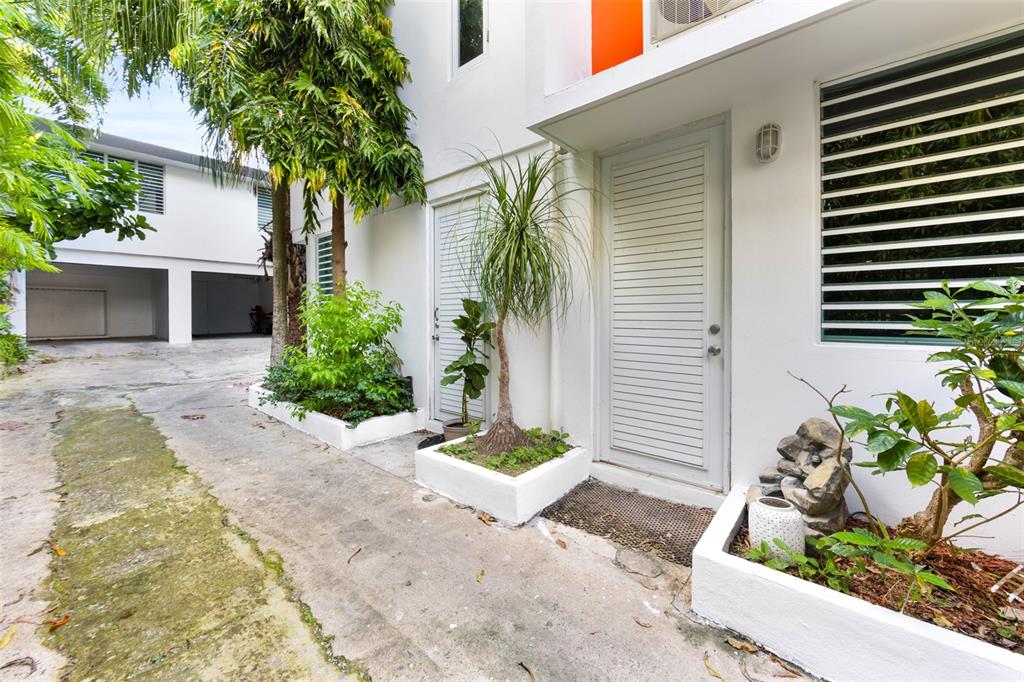 An exterior view of a white building with a louvered door and concrete planters — 424 DEL VALLE ST MONTEFLORES DEV, SAN JUAN, PR