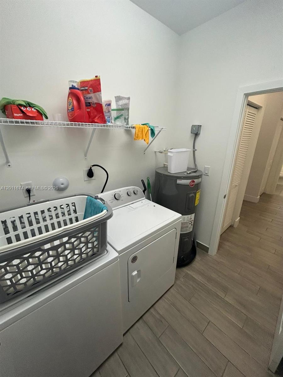 A laundry room features a washer, dryer, water heater, and a wire storage shelf — 5541 AGOSTINO WAY # 5541, Ave Maria FL 34142, AVE MARIA, FL