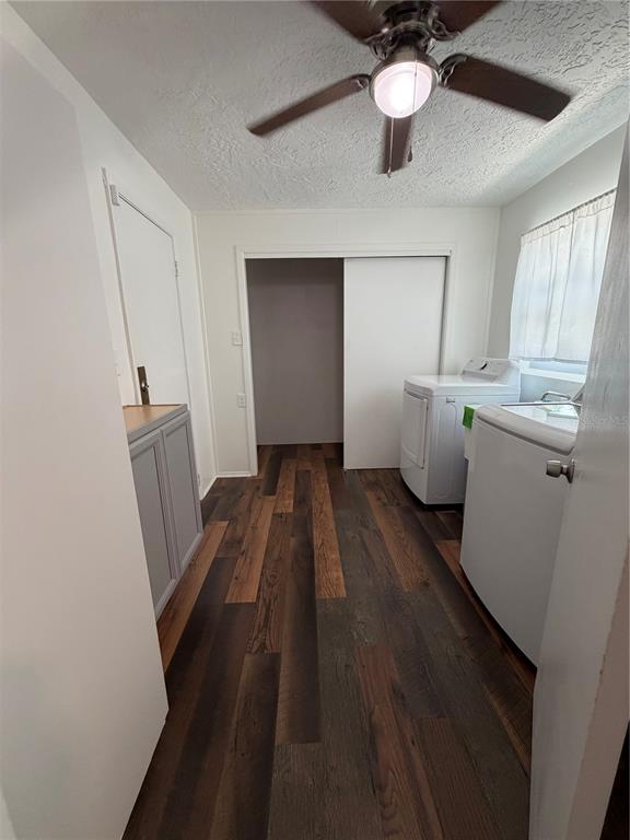 A laundry room features wood-look flooring, a ceiling fan, white appliances, and a sliding closet — 320 S HARRISON STREET, BEVERLY HILLS, FL