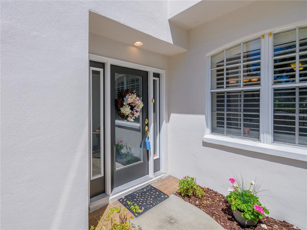 A front entryway features a dark gray door with a wreath and a side window — 204 S LINCOLN AVENUE, TAMPA, FL