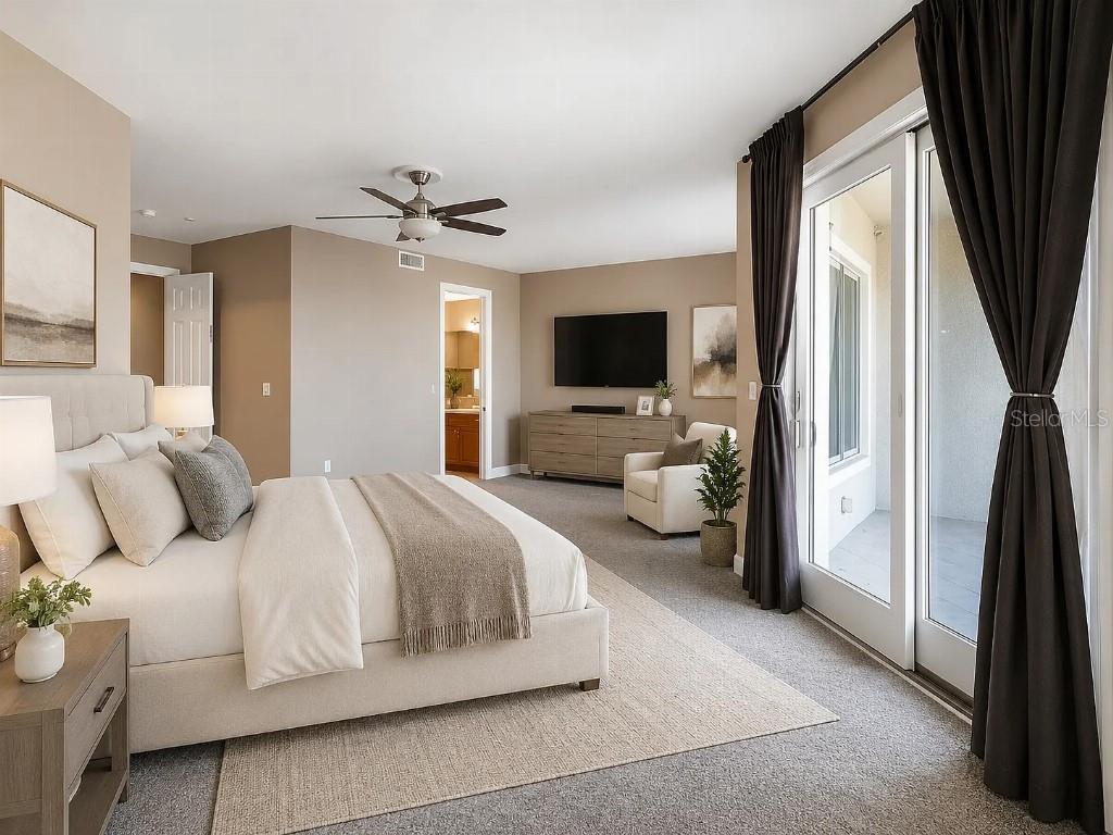 A bedroom features a king bed, neutral walls, a ceiling fan, and sliding glass doors — 1714 PARK STREET N, ST PETERSBURG, FL