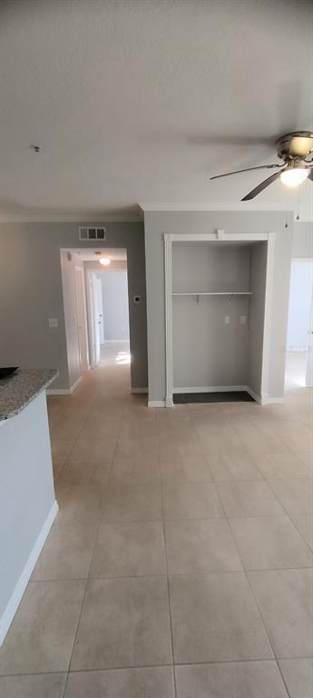 An interior view shows a tiled room with a recessed alcove and a hallway entrance — 2544 ROBERT TRENT DRIVE UNIT 825, ORLANDO, FL