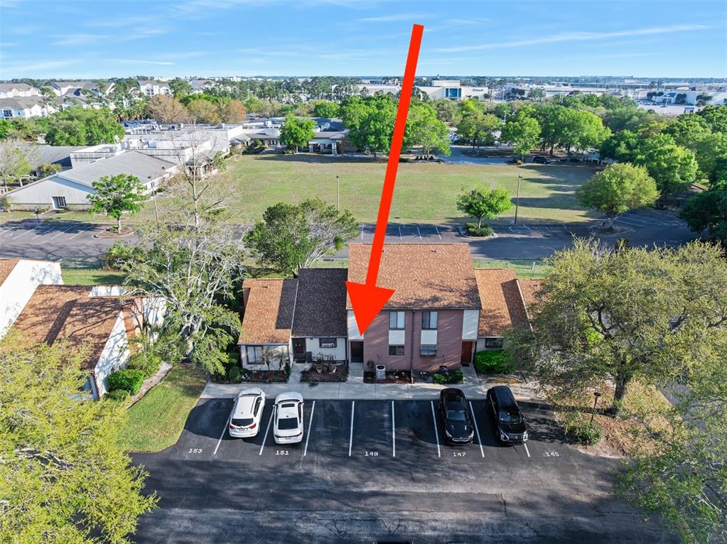 An aerial view shows a two-story townhouse with a red arrow pointing to the entrance — 149 WHITE FAWN DRIVE UNIT 1490, DAYTONA BEACH, FL