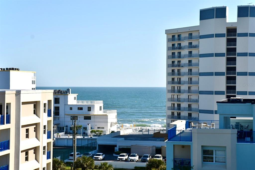 An exterior view of a beachside resort with multiple buildings overlooking the ocean — 5300 S ATLANTIC AVENUE UNIT 8-402, NEW SMYRNA BEACH, FL