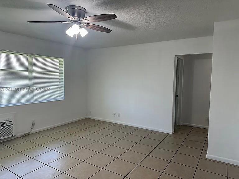 A room with white walls, tile flooring, a ceiling fan, and a window with blinds — 2407 Mckinley St # 2, Hollywood FL 33020, HOLLYWOOD, FL