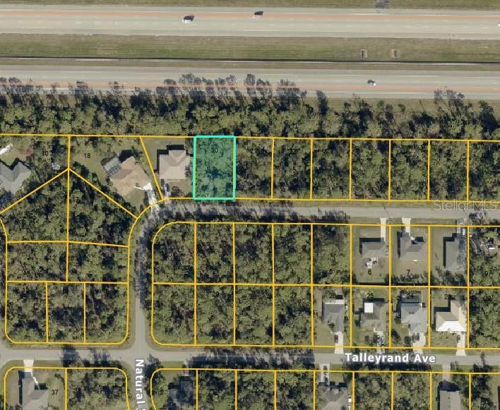 This is an aerial map showing a highlighted vacant residential lot in a suburban neighborhood — SNUG STREET, NORTH PORT, FL