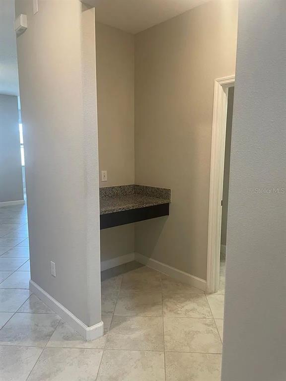 A small alcove features a granite countertop desk area with a wall outlet — 9671 IVORY DRIVE, SUN CITY CENTER, FL