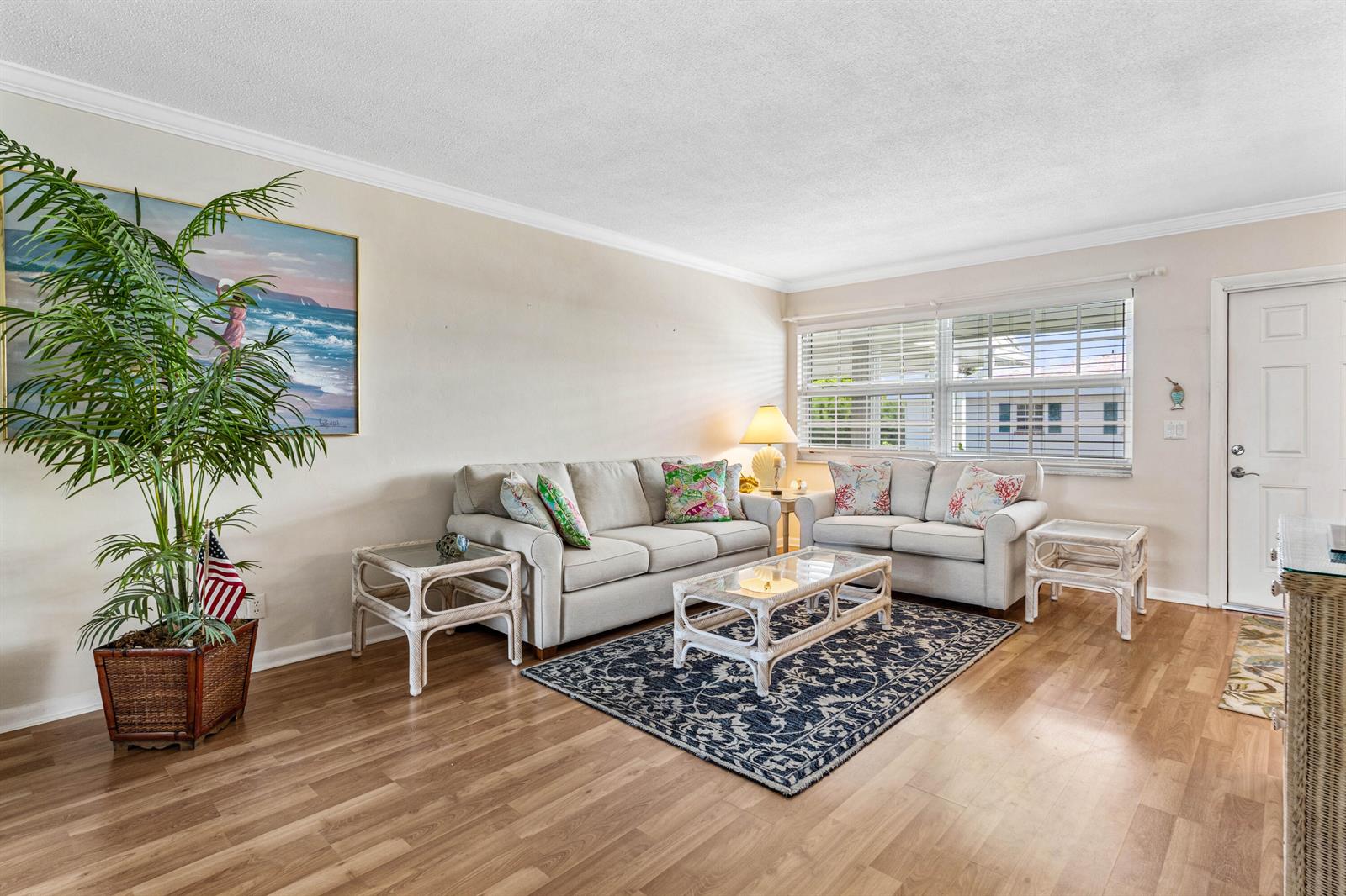 A living room features light-colored sofas, a patterned area rug, and a large potted plant — 5505 N Ocean Boulevard # 204, Ocean Ridge FL 33435, OCEAN RIDGE, FL