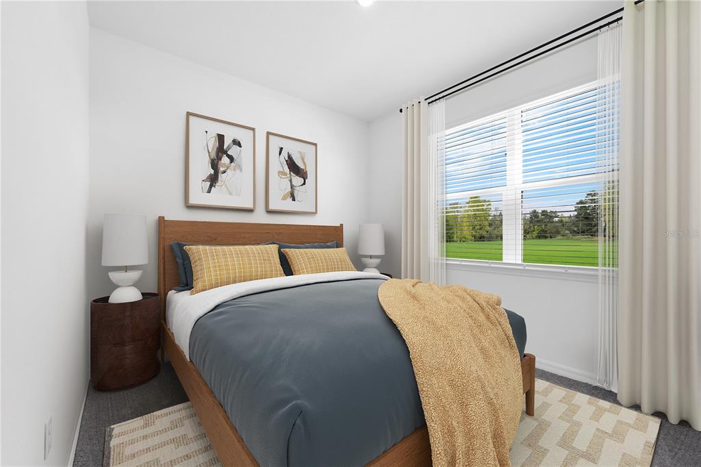 A bedroom features a wooden bed frame, blue bedding, yellow accents, and a large window — 1825 AMERICAN WAY, HAINES CITY, FL