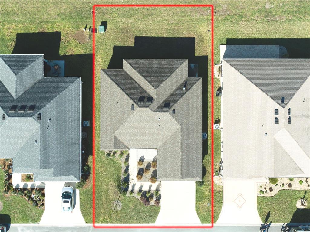 An aerial view shows a single-family home centered on a rectangular lot — 6522 MCKNIGHT LOOP, THE VILLAGES, FL