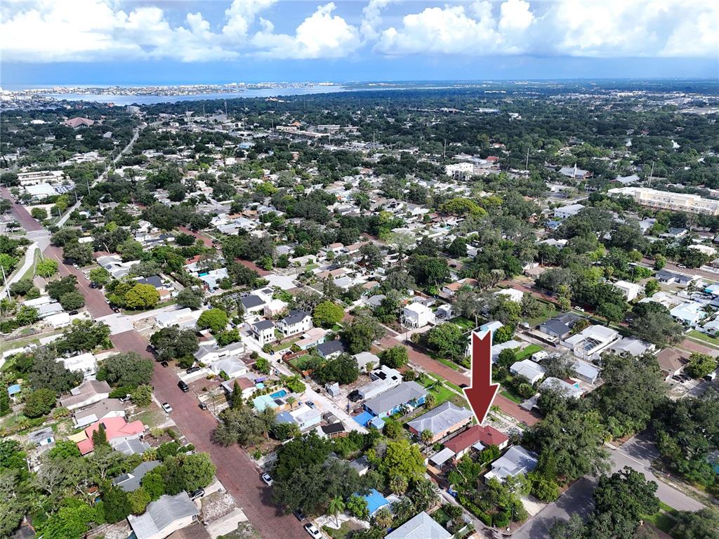 An aerial view shows a residential neighborhood with a red arrow pointing to a house — 6210 4TH AVENUE S, ST PETERSBURG, FL
