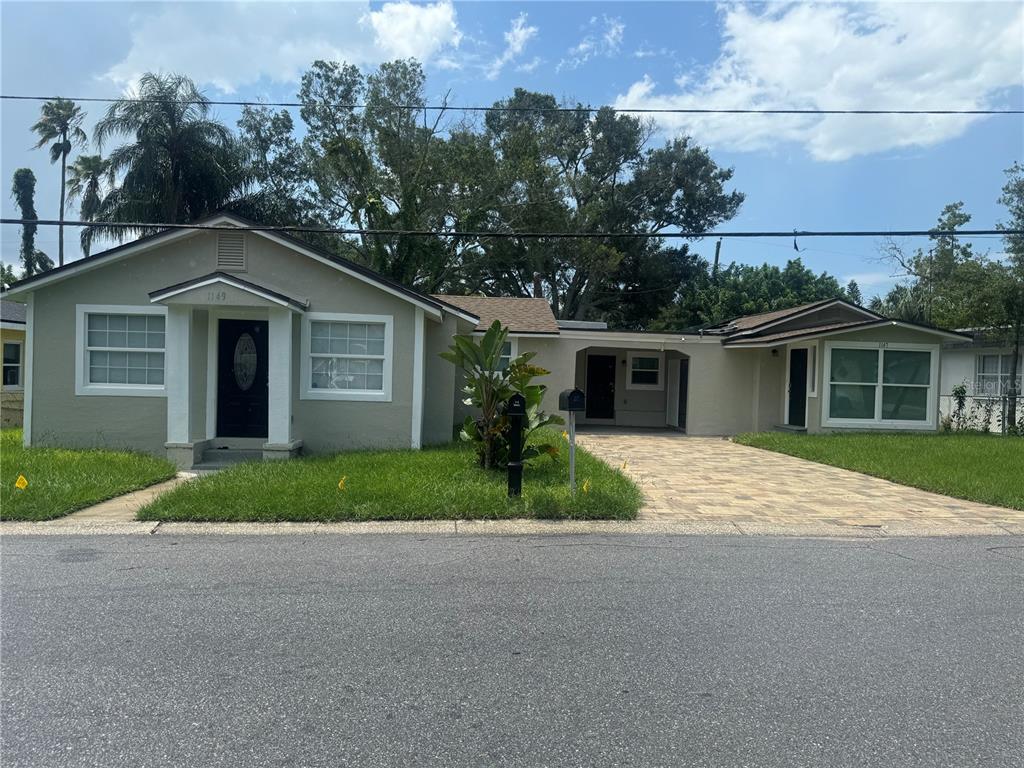 A single-story house with a paved driveway, a carport, and a small front yard — 1149 LA SALLE STREET, CLEARWATER, FL