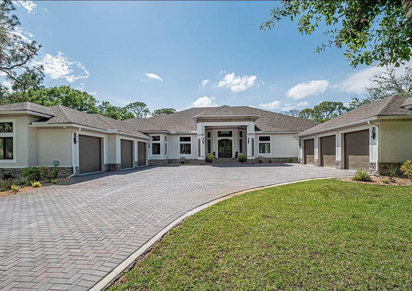 A large single-story house with a paved driveway and six garage bays — 145 24th Avenue, Vero Beach FL 32962, VERO BEACH, FL