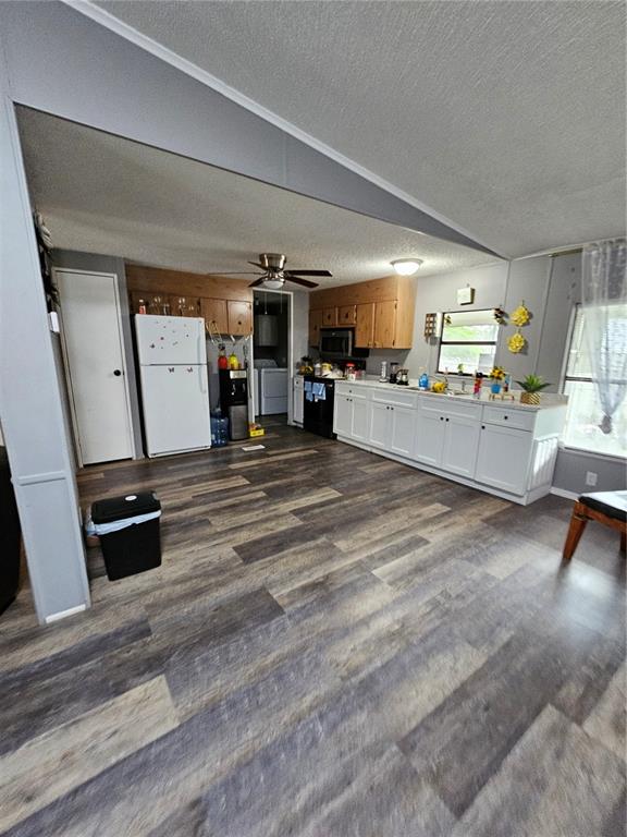 A kitchen with white lower cabinets, wood upper cabinets, and wood-look plank flooring — 6980 NE 4TH LANE, OCALA, FL