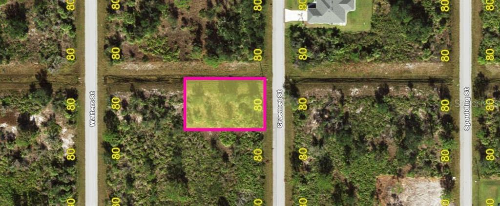 This is an aerial map view of a rectangular vacant lot highlighted in pink — 303 CRAEMER STREET, PORT CHARLOTTE, FL