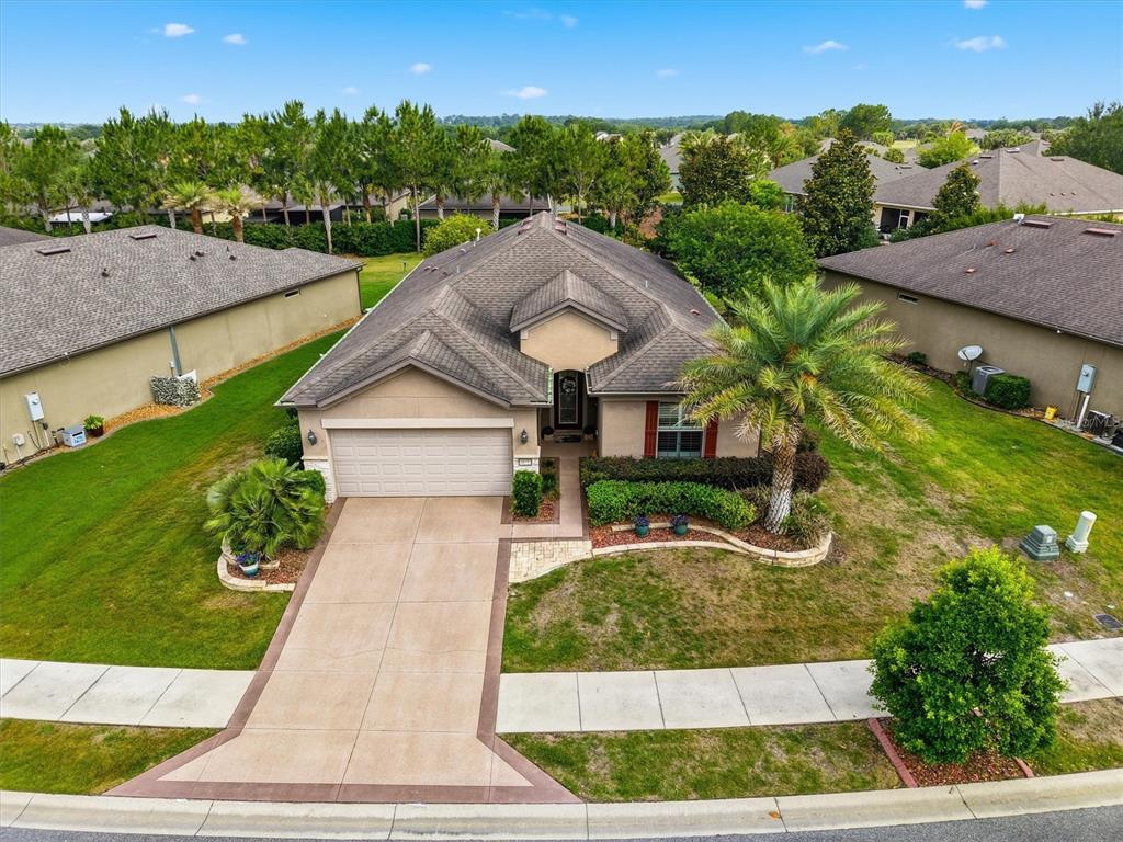 An aerial view of a single-story suburban house with a driveway and palm tree — 9641 SW 76TH PLACE, OCALA, FL