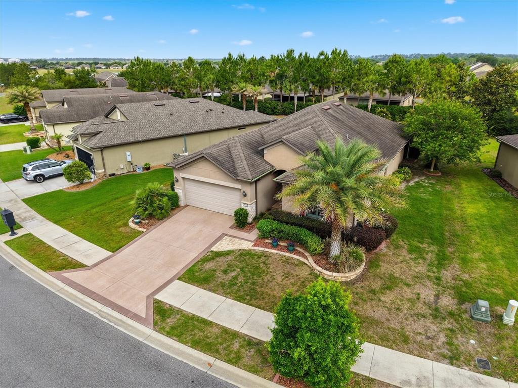 An aerial view shows a single-story suburban house with a two-car garage and palm tree — 9641 SW 76TH PLACE, OCALA, FL