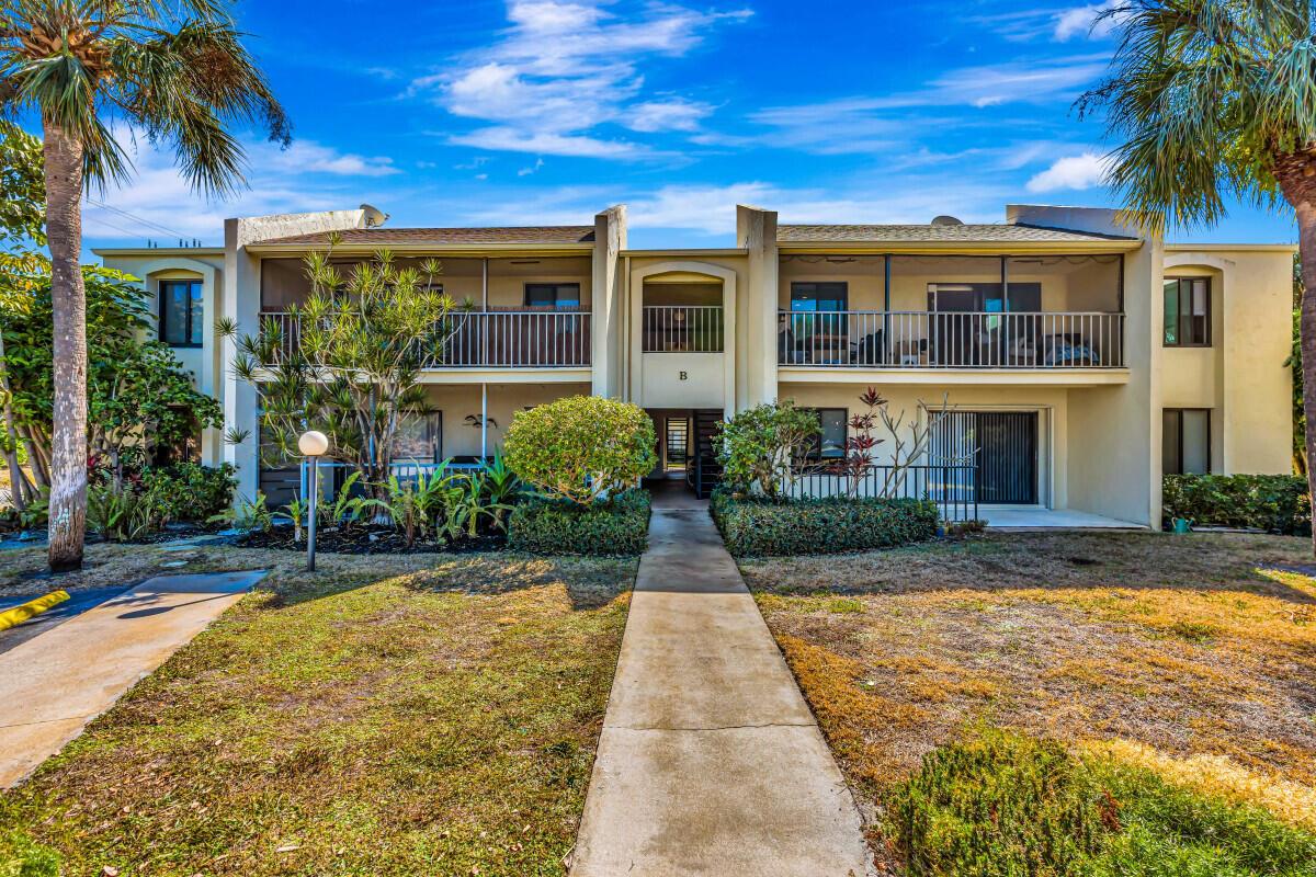 A two-story apartment building with balconies and a central walkway leading to the entrance — 150 Pineview Road # B2, Jupiter FL 33469, JUPITER, FL