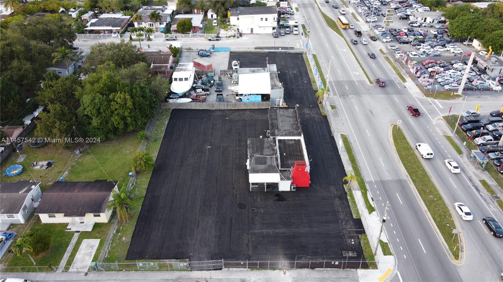 An aerial view shows a commercial lot with a building and paved parking area — 9800 NW 27th Ave, Miami FL 33147, MIAMI, FL