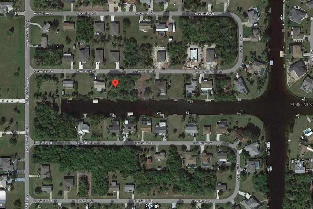 This is an aerial map view of a residential neighborhood featuring homes along a canal — 18210 AVONSDALE CIRCLE, PORT CHARLOTTE, FL