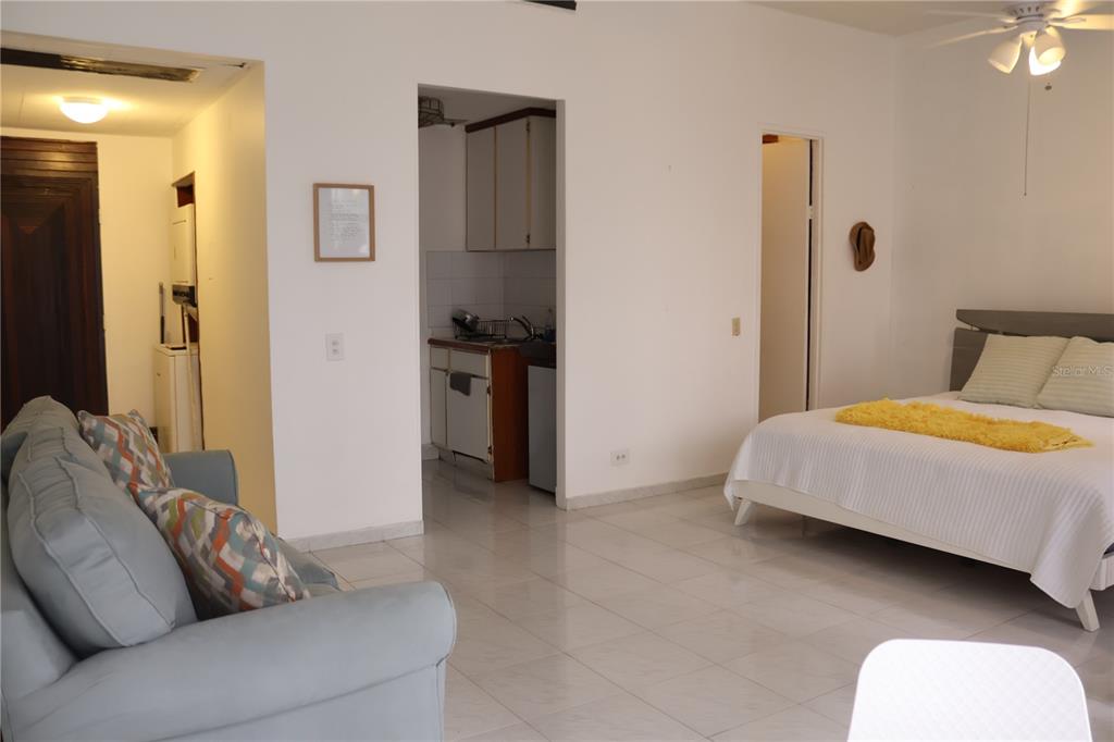 A studio apartment features a sofa, a bed, and a small kitchen area with tile floors — 6410 AVE ISLA VERDE UNIT G5, CAROLINA, PR