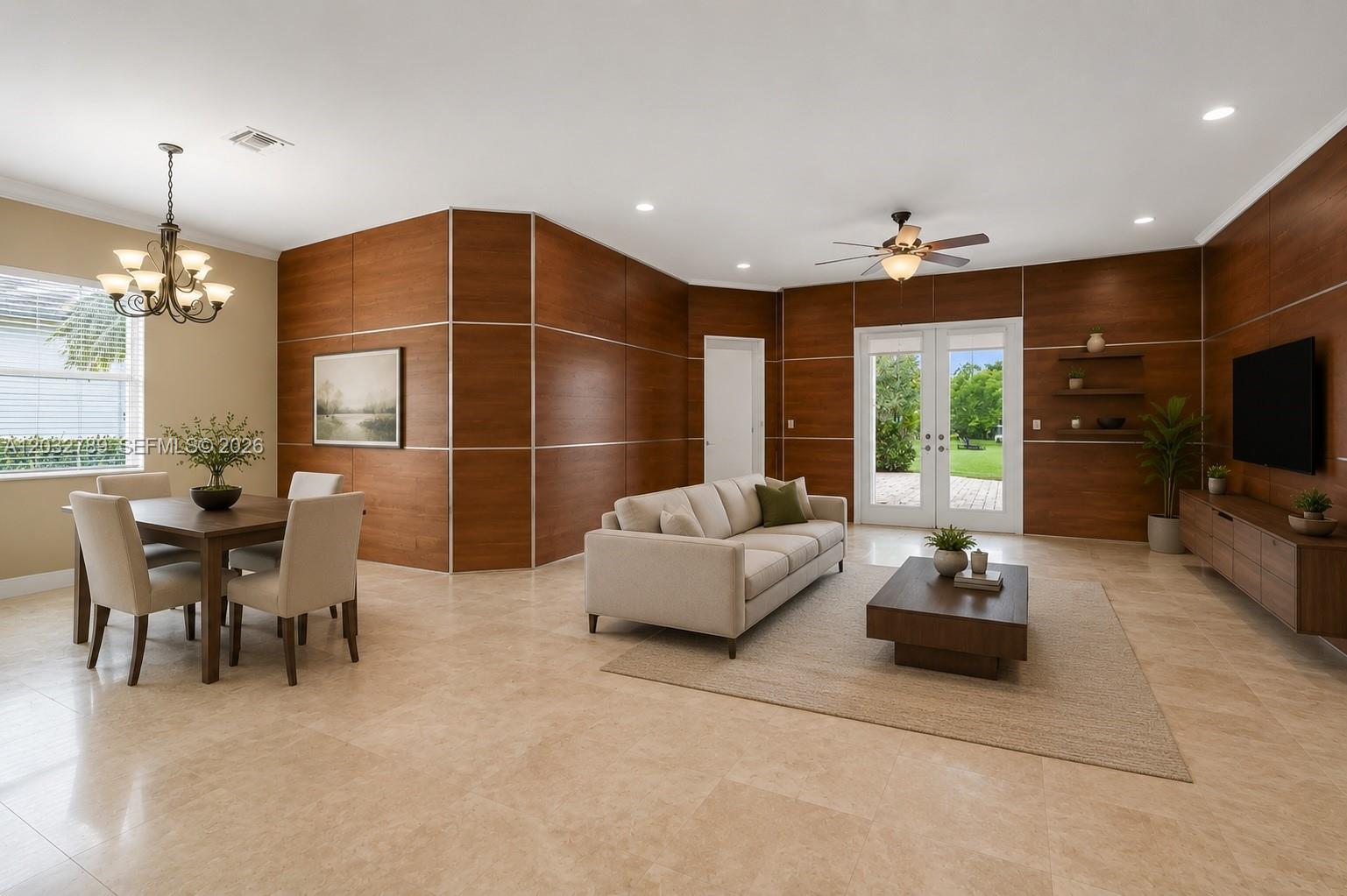 An open-concept living and dining area features wood-paneled walls, tile flooring, and glass patio doors — 19301 Seneca Ave, Weston FL 33332, WESTON, FL