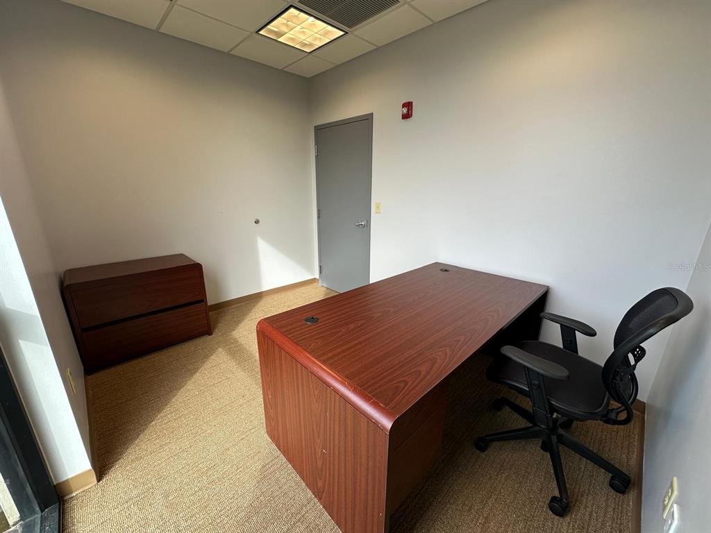 An office room features a wooden desk, a black rolling chair, and a filing cabinet — 1525 INTERNATIONAL PARKWAY UNIT 4071, LAKE MARY, FL