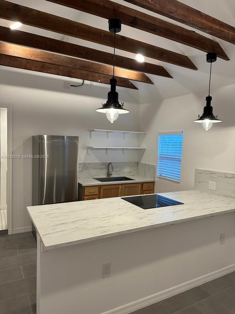 A kitchen features a marble-look island, wooden ceiling beams, pendant lighting, and open shelving — 3113 SW 14th St # A, Miami FL 33145, MIAMI, FL