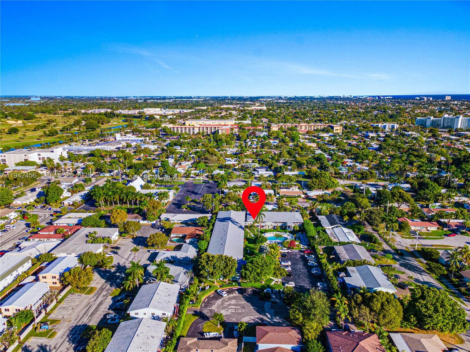 An aerial view shows a residential apartment complex with a pool and parking lot — 2541 NE 11th St # 212, Pompano Beach FL 33062, POMPANO BEACH, FL