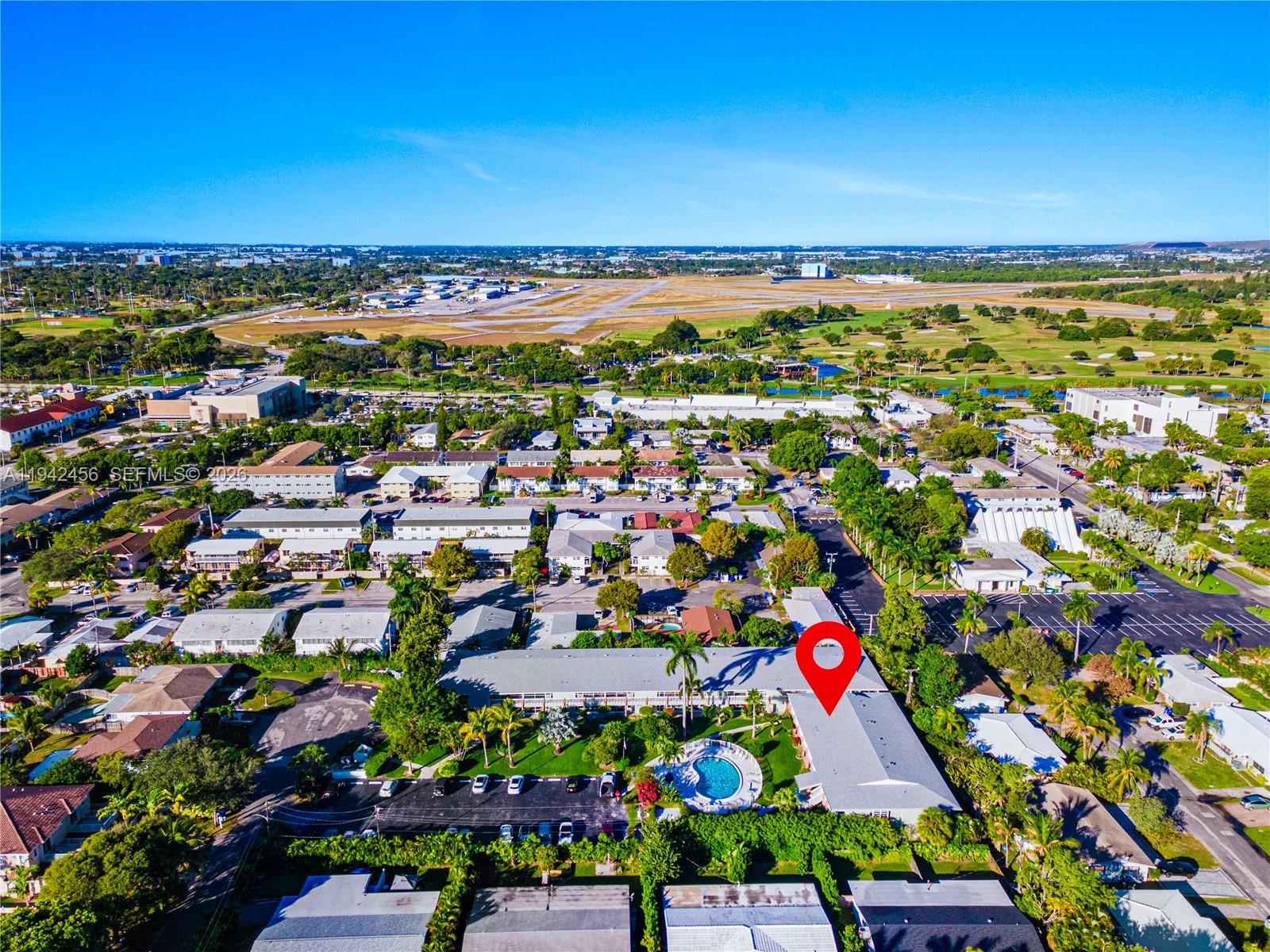 An aerial view shows a multi-unit residential complex with a swimming pool and parking lot — 2541 NE 11th St # 212, Pompano Beach FL 33062, POMPANO BEACH, FL