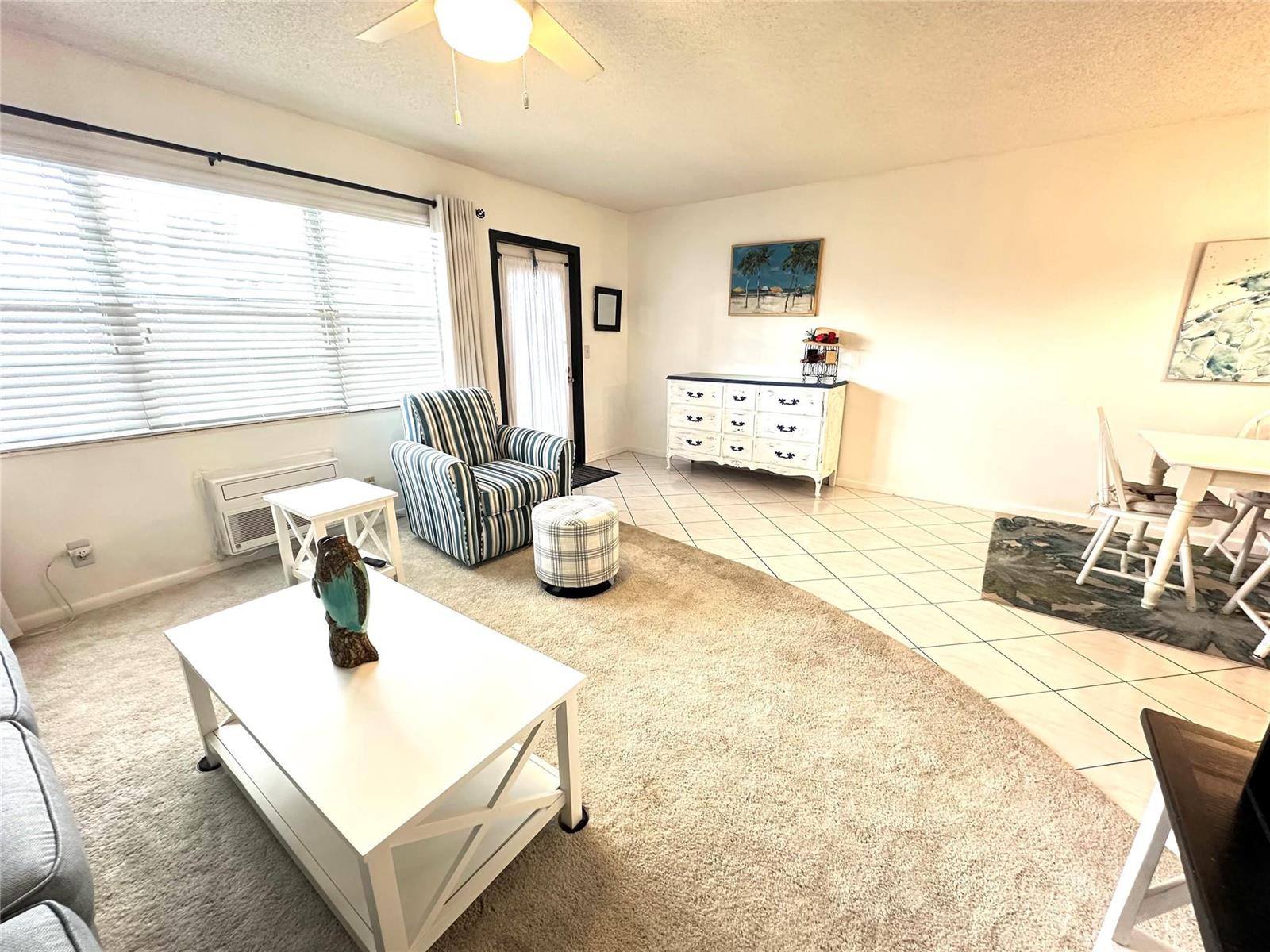 A living room features a white coffee table, a striped armchair, and a white dresser — 131 Oakridge J # 131, Deerfield Beach FL 33442, DEERFIELD BEACH, FL