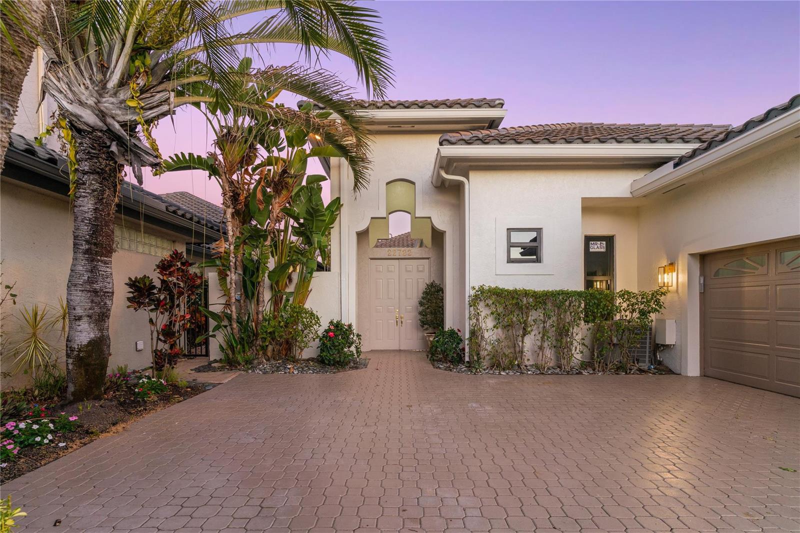 A paved driveway leads to the front entrance of a stucco house with palm trees — 22722 El Dorado Drive, Boca Raton FL 33433, BOCA RATON, FL